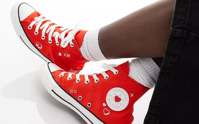 A Woman Wearing Converse Chuck Taylor All Star Sneakers with Heart Embroidery in Red