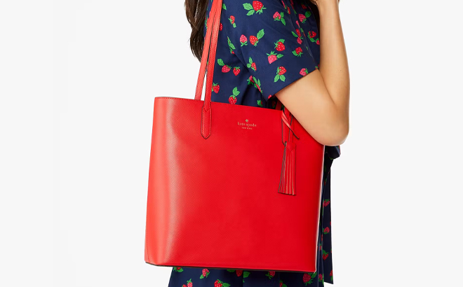 A Woman Wearing Kate Spade Jana Tote in Currant Jam