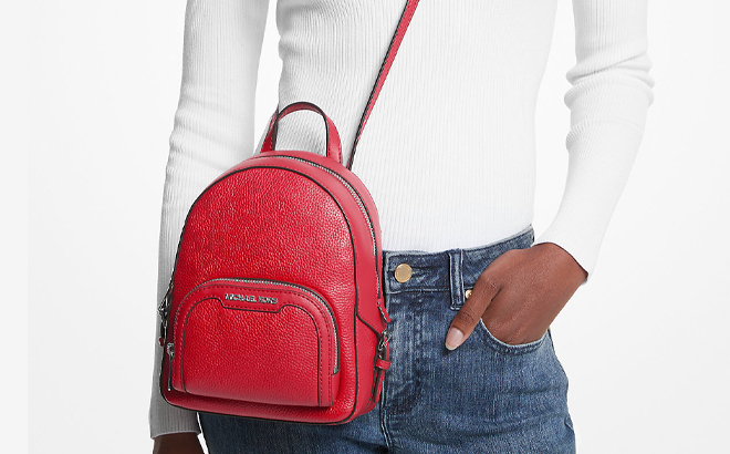 A Woman Wearing Michael Kors Jaycee Extra Small Convertible Backpack