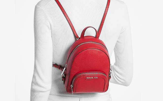 A Woman Wearing Michael Kors Jaycee Extra Small Pebbled Leather Convertible Backpack