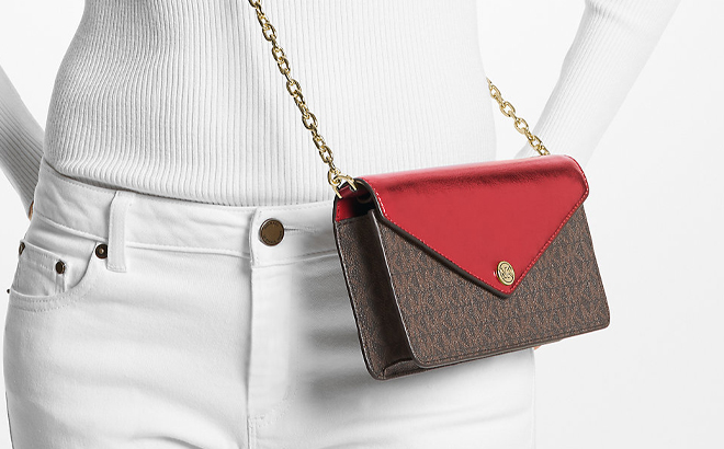 A Woman Wearing Michael Kors Jet Set Travel Small Clutch Crossbody Bag