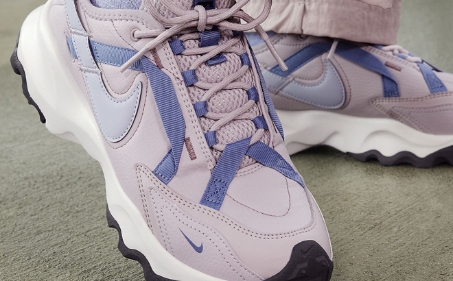 A Woman Wearing Nike TC 7900 Shoes A Woman Wearing Nike TC 7900 Shoes