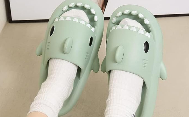 A Woman Wearing Shark Slides in Light Green Color