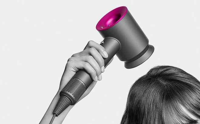 A lady holding Dyson Supersonic Hair Dryer