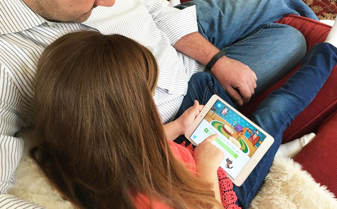 Dad and Daughter Exploring Homer Learning App on a Tablet