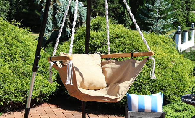 Dakota Fields Porch Swing Chair in the Color Beige on a Patio Dakota Fields Porch Swing Chair in the Color Beige on a Patio