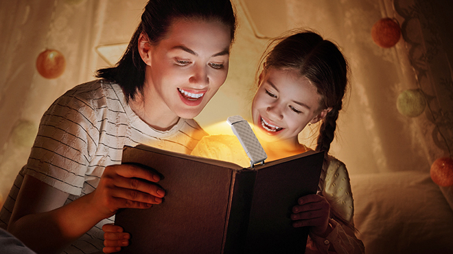 People Rading with a Booklight Attached to a Book People Rading with a Booklight Attached to a Book