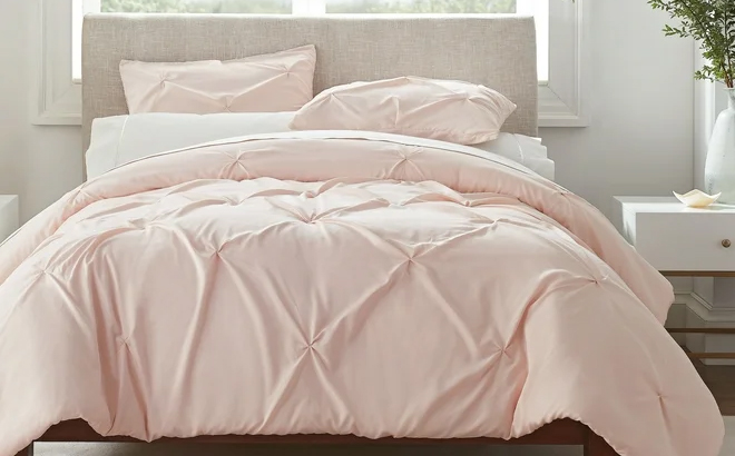 Serta Simply Clean Pleated 3 Piece Solid Duvet Set on a Bed in the Color Pink