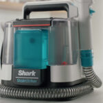 Shark StainStriker Portable Carpet Cleaner with Pet Mess Tool on a Table