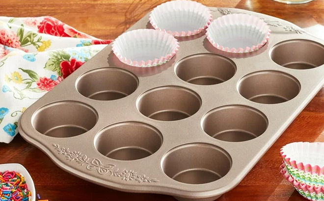 The Pioneer Women 12 cup Muffin Pan on a Kitchen Counter with Muffin Wrappers