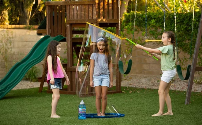 Three Kids Playing with Giant Bubbles Kid In A Bubble Wand