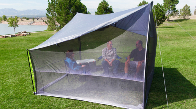 Three People Sitting Inside Ozark Trail Tarp Shelter