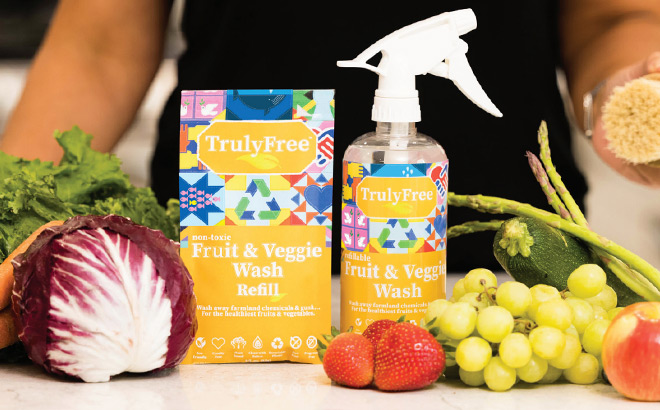 Truly Free Fruit Veggie Wash Next to Vegetables and Fruits on a Kitchen Countertop