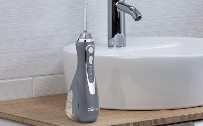 Waterpik Cordless Advanced Water Flosser on a Wooden Table
