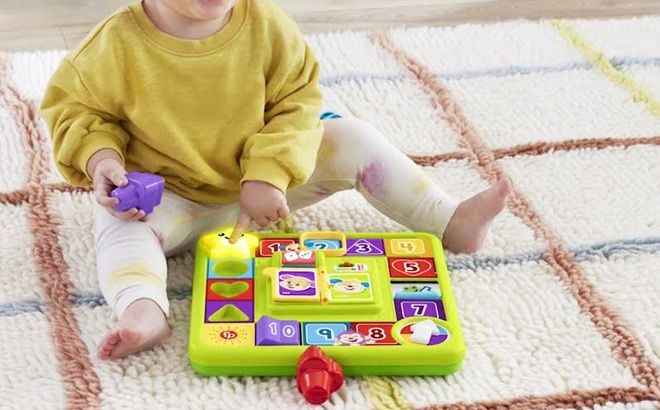 a Kid Playing with Fisher Price Laugh Learn Puppys Game Activity Board
