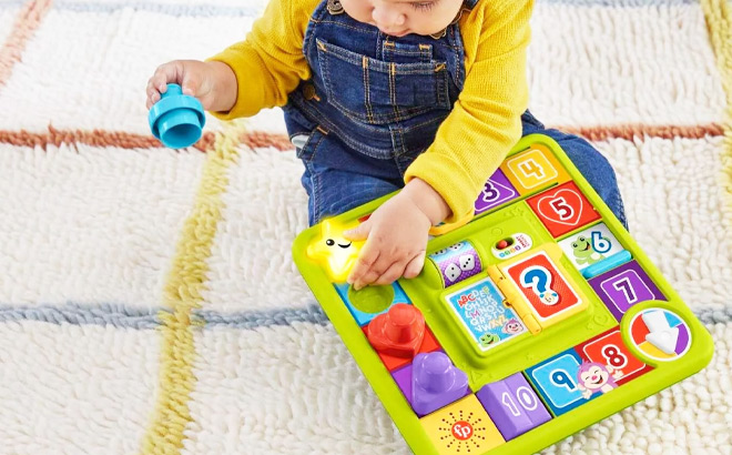 a Kid Playing with Fisher Price Laugh and Learn Toy Puppys Game Activity Board