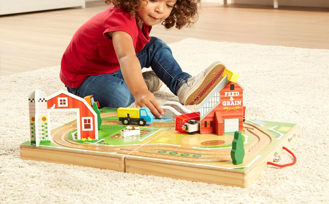 a Kid Playing with Melissa Doug 17 Piece Farm Playset