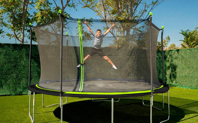 a Kid in the 14 Foot Trampoline With Enclosure Combo