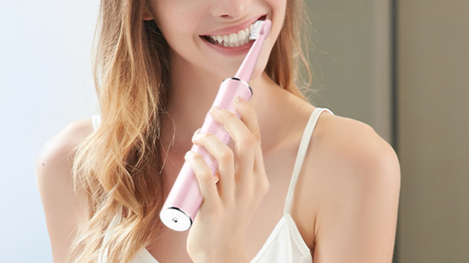 a Person Using Sonic Electric Toothbrush a Person Using Sonic Electric Toothbrush
