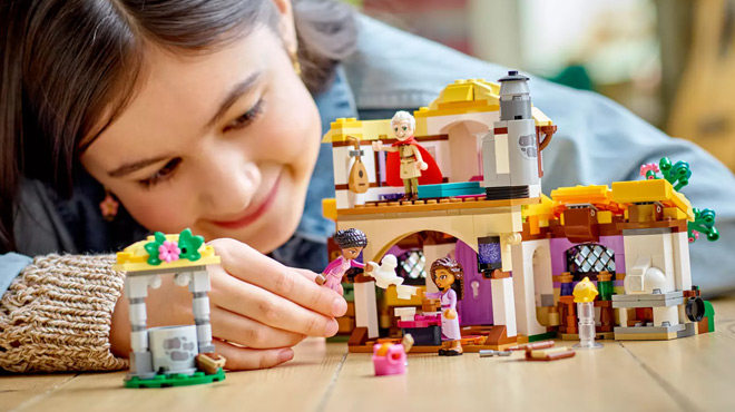 A Child Playing with LEGO Ashas Cottage Set A Child Playing with LEGO Ashas Cottage Set
