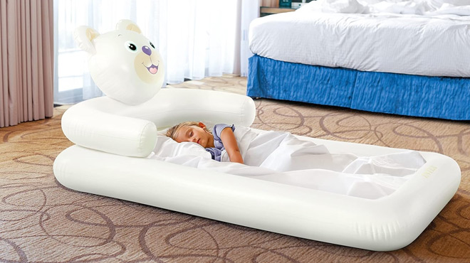 A Child SLeeping on a Intex Bear Kidz Inflatable Travel Bed Set