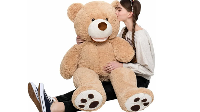 A Girls Playing with MorisMos Stuffed Animal Giant Teddy Bear
