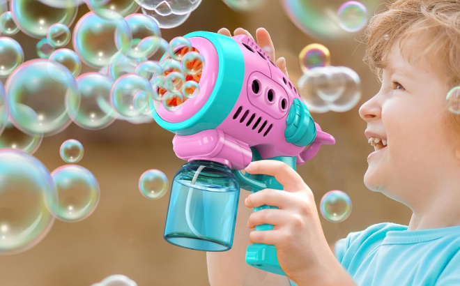 A Kid Playing with a Bubble Gun A Kid Playing with a Bubble Gun