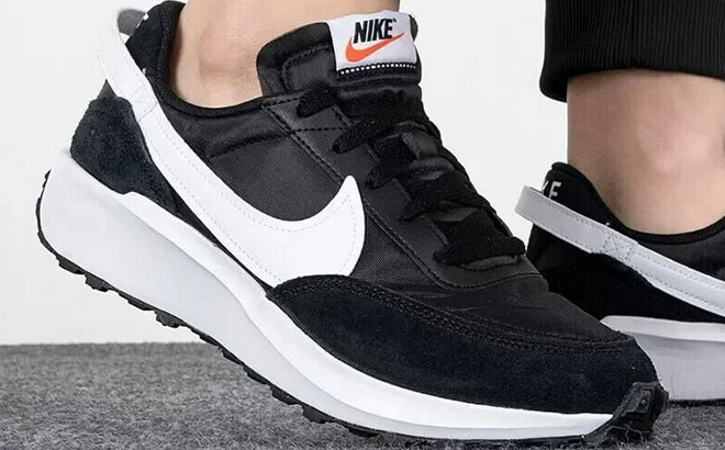 A Man Wearing Nike Waffle Debut Running Sneakers A Man Wearing Nike Waffle Debut Running Sneakers