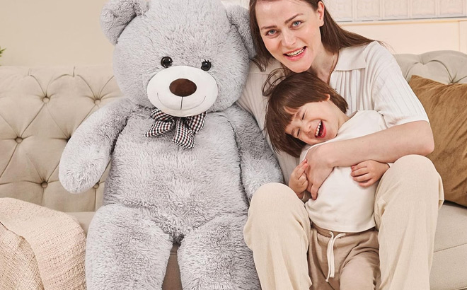 A Mother and Child Posing Beside a Giant 47 inch Teddy Bear Plush Toy