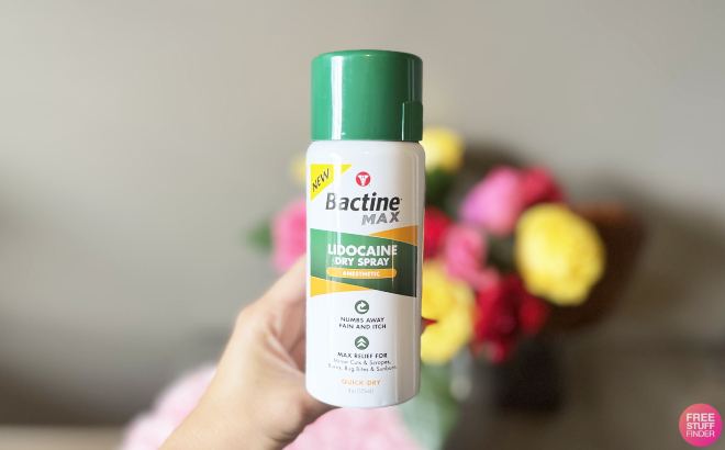 A Pereson Holding a Bactine Max Dry Spray