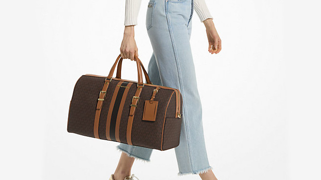 A Person Carrying a Michael Kors Travel Extra Large Weekender Bag