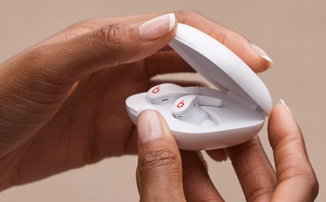A Person Holding Beats Fit Pro Noise Cancelling Earbuds in White Color