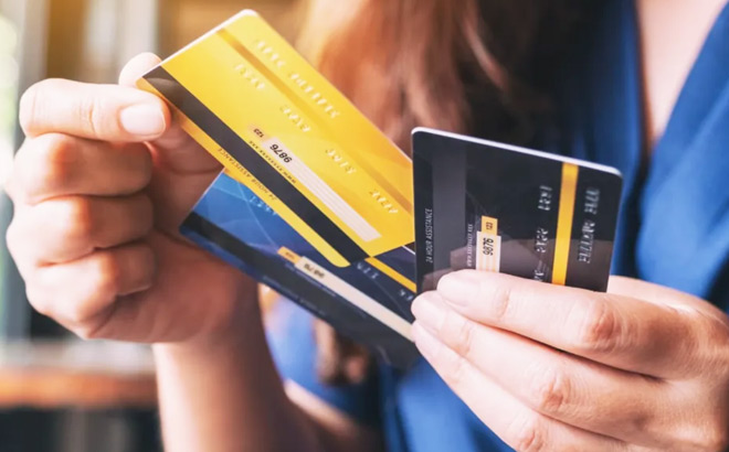 A Person Holding Credit Cards