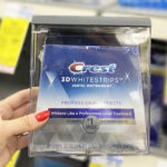 A Person Holding Crest 3D Whitestrips Professional Effects Whitening Kit
