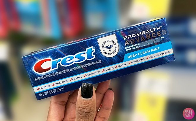 A Person Holding Crest Pro Health Toothpaste Deep Clean Mint