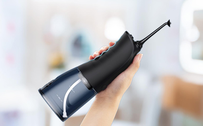 A Person Holding Demita Cordless Water Flosser