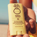 A Person Holding Sun Bum Kids SPF 50 Clear Sunscreen Face Stick