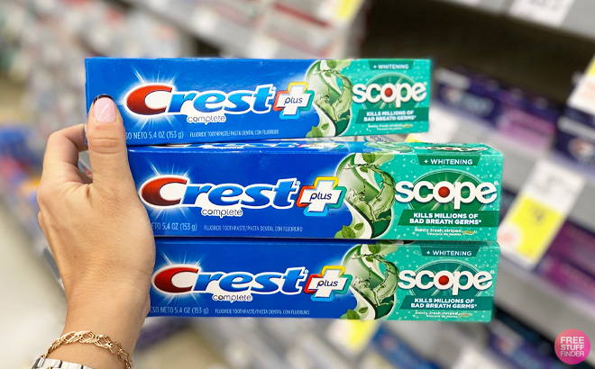 A Person Holding Three Crest Scope Toothpaste Deep Clean Mint