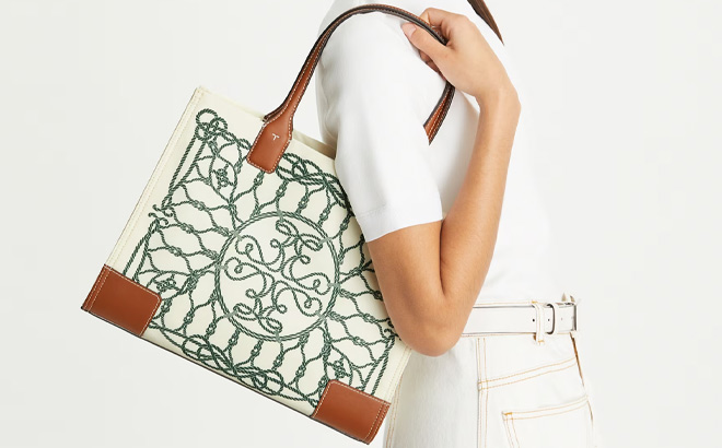 A Person Holding Tory Burch Small Ella Printed Tote in Ivory Abstract Rope Color A Person Holding Tory Burch Small Ella Printed Tote in Ivory Abstract Rope Color