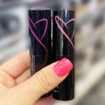 A Person Holding Two NYX Shout Loud Satin Lipsticks