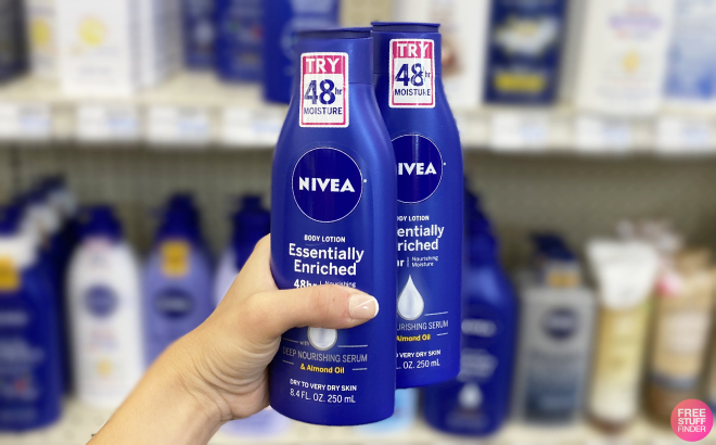 A Person Holding Two bottles of Nivea Essentially Enriched Body Lotion