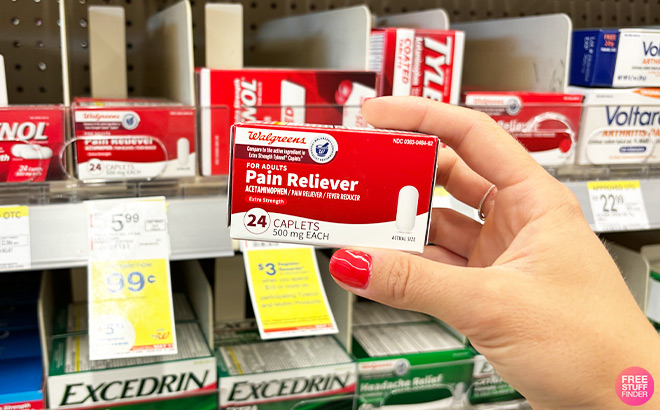 A Person Holding Walgreens Extra Strength Acetaminophen Caplets in a Store Aisle