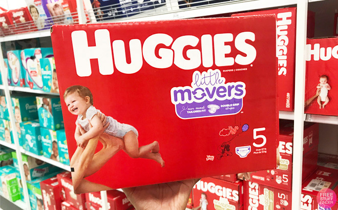 A Person Holding a Box of Huggies Little Movers Baby Disposable Diapers Size 5