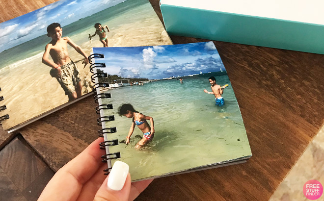 A Person Holding a Mini Photo Book