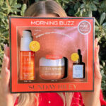 A Person Holding the Sunday Riley Morning Buzz 3 Piece Set