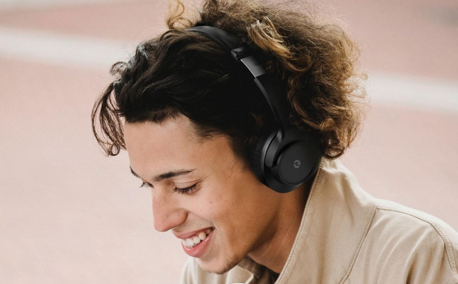 A Person Listening to Music Using Willmood Wireless Bluetooth Headphones
