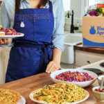 A Person Showing Several Meals That Were Prepared from a Blue Apron Meal Box