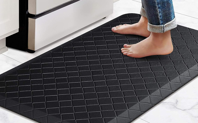 A Person Stepping on a Happy Trends Anti Fatigue Floor Mat A Person Stepping on a Happy Trends Anti Fatigue Floor Mat