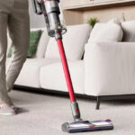 A Person Using Dyson Outsize Cordless Vacuum Cleaner
