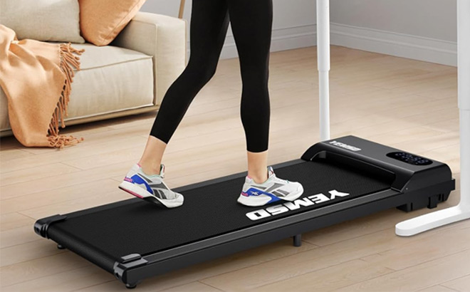 A Person Using Yemsd Walking Pad in Black Color